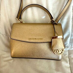 Michael Kors gold mini purse with strap.  Used one time, like new!